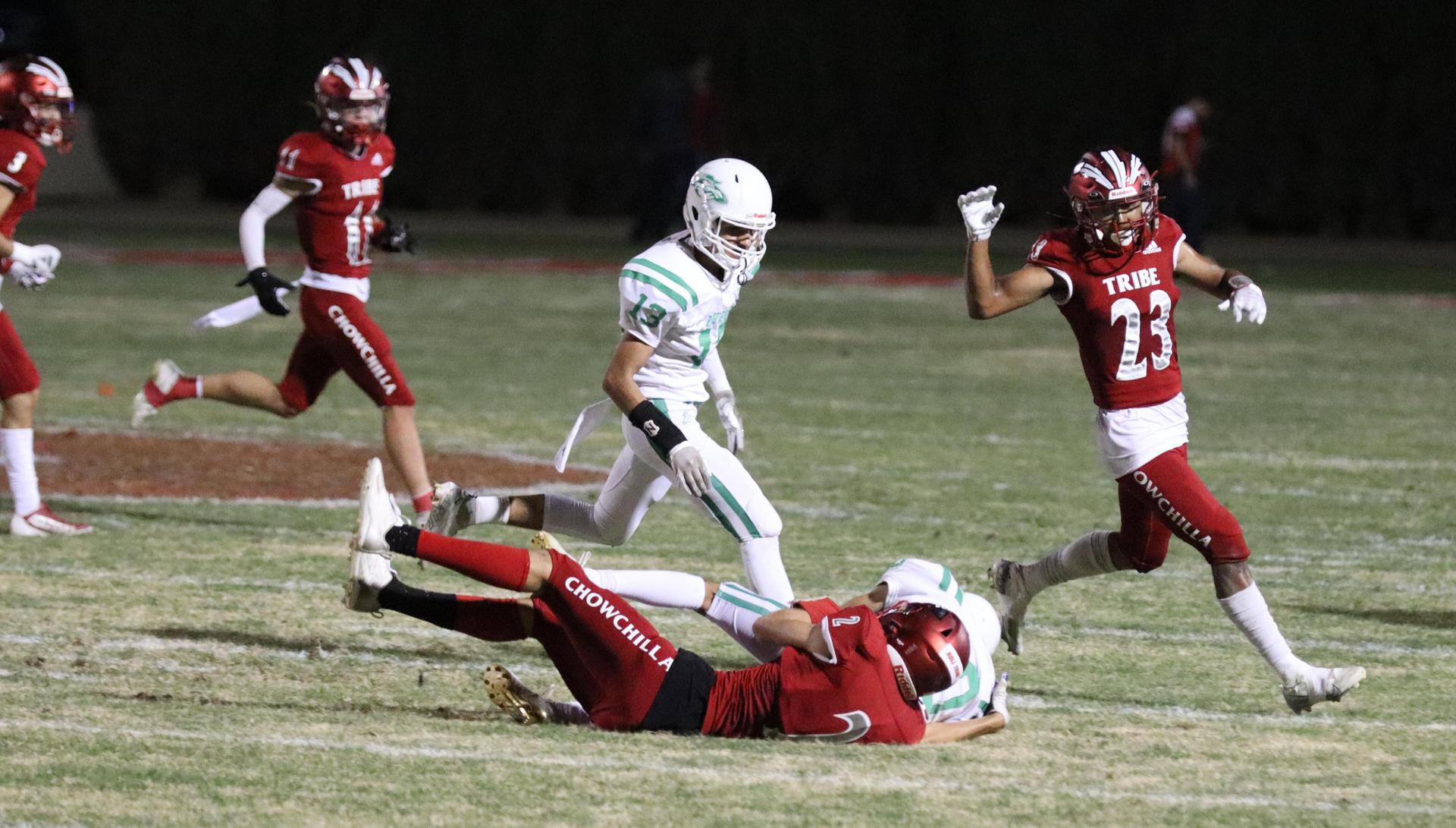 varsity football players in action against Riverdale