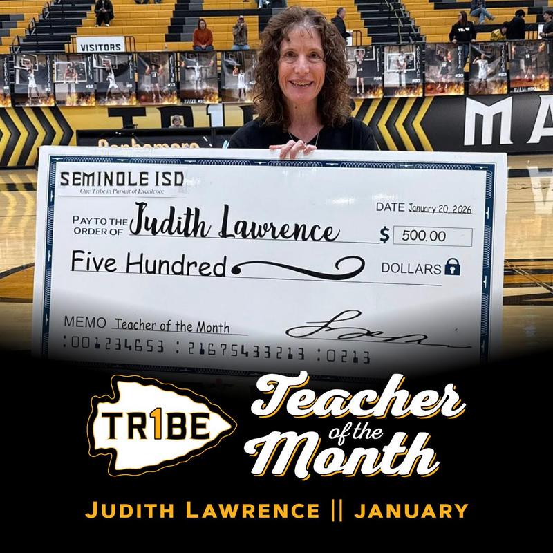 Judith Lawrence standing with her Teacher of the Month check