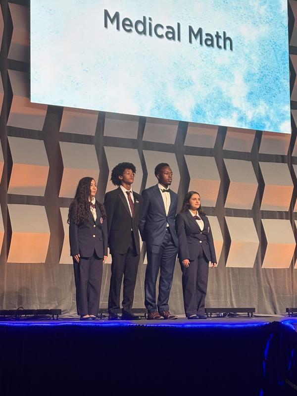 Smiling teens dressed in professional attire