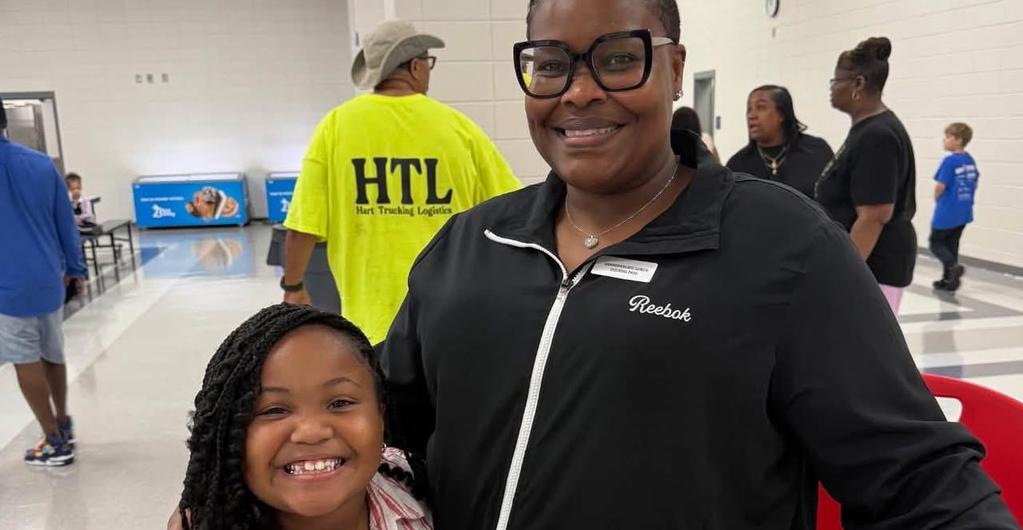 Student poses with family for Grandparent's lunch