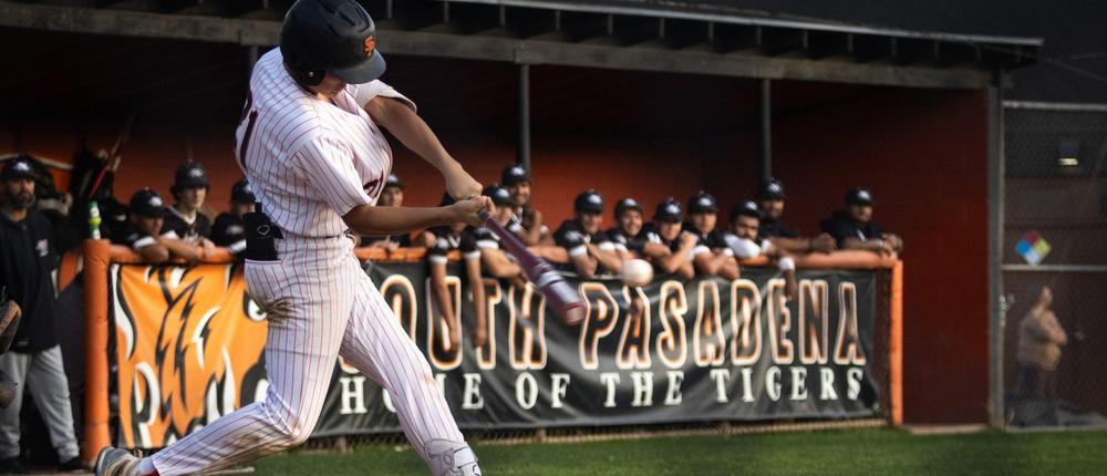 baseball player hitting the ball