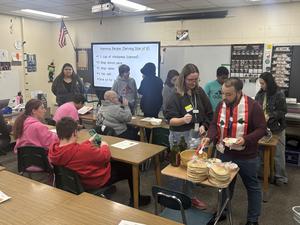 In a lively cooking session, students prepare hummus while serving it alongside pita bread.
