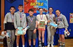 six students with prize bags posing for a picture