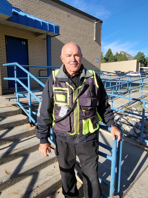Carl Pederson standing on steps of school