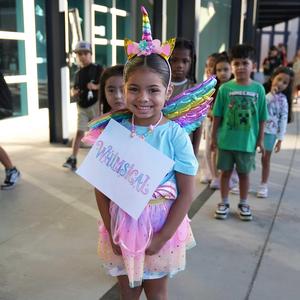 girl dressed in pastels with "whimsical" name sign