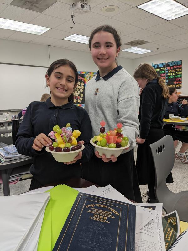 two girls show off their edible flower arrangements.