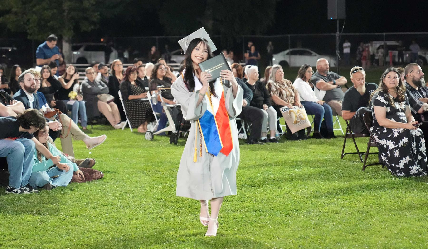 SJLA Graduate showing diploma