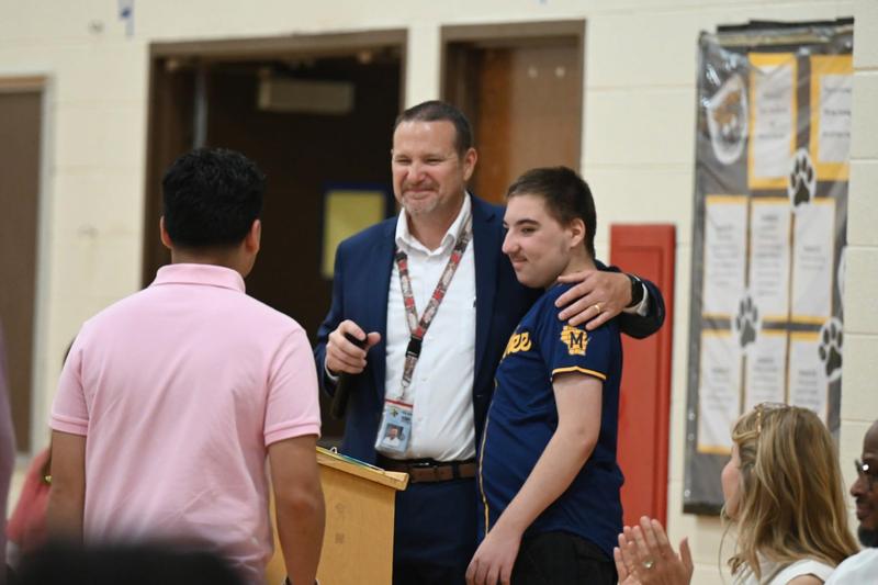 principal at 8th grade compeltion ceremony with student