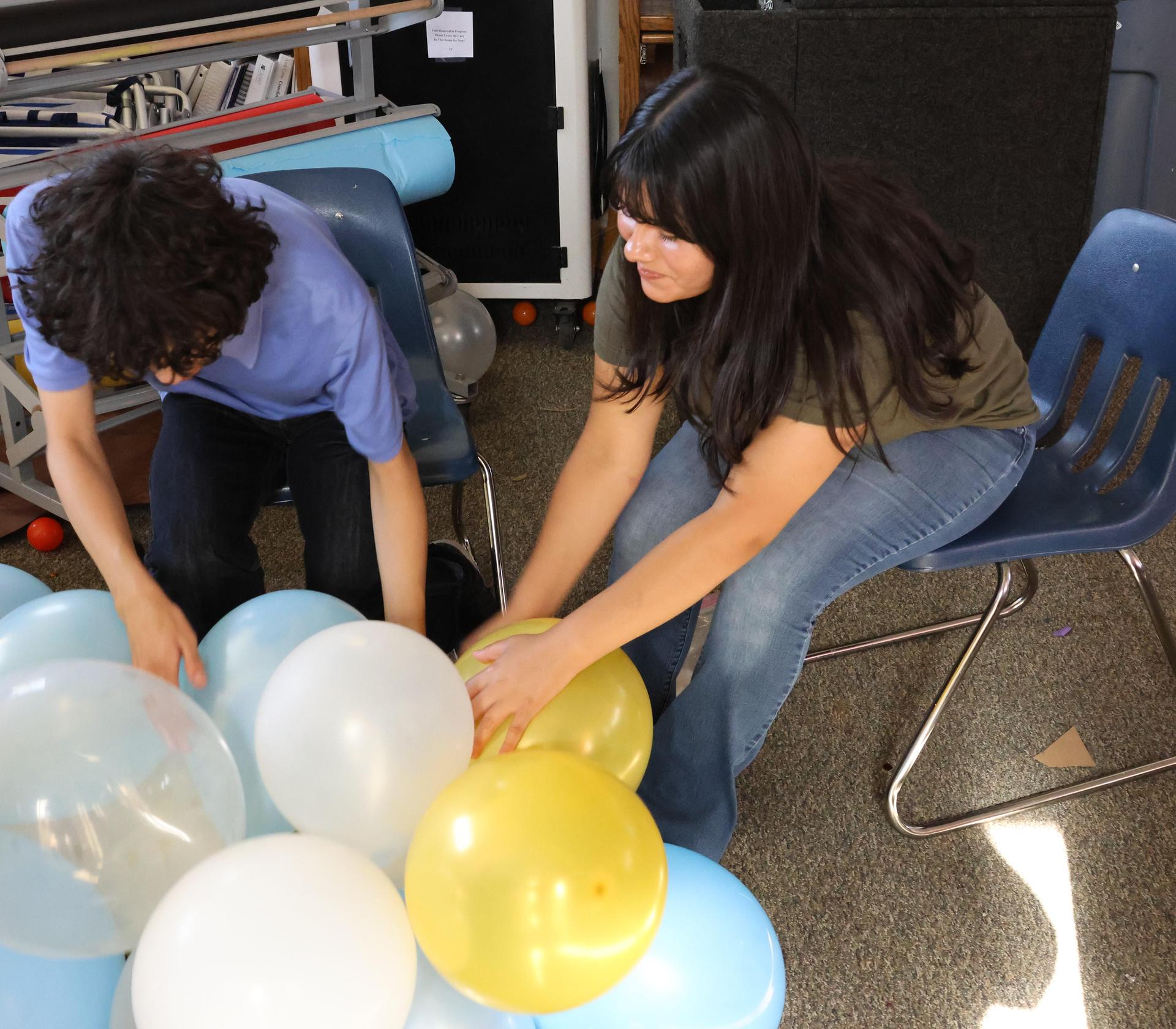 students, parents, and staff building floats for homecoming