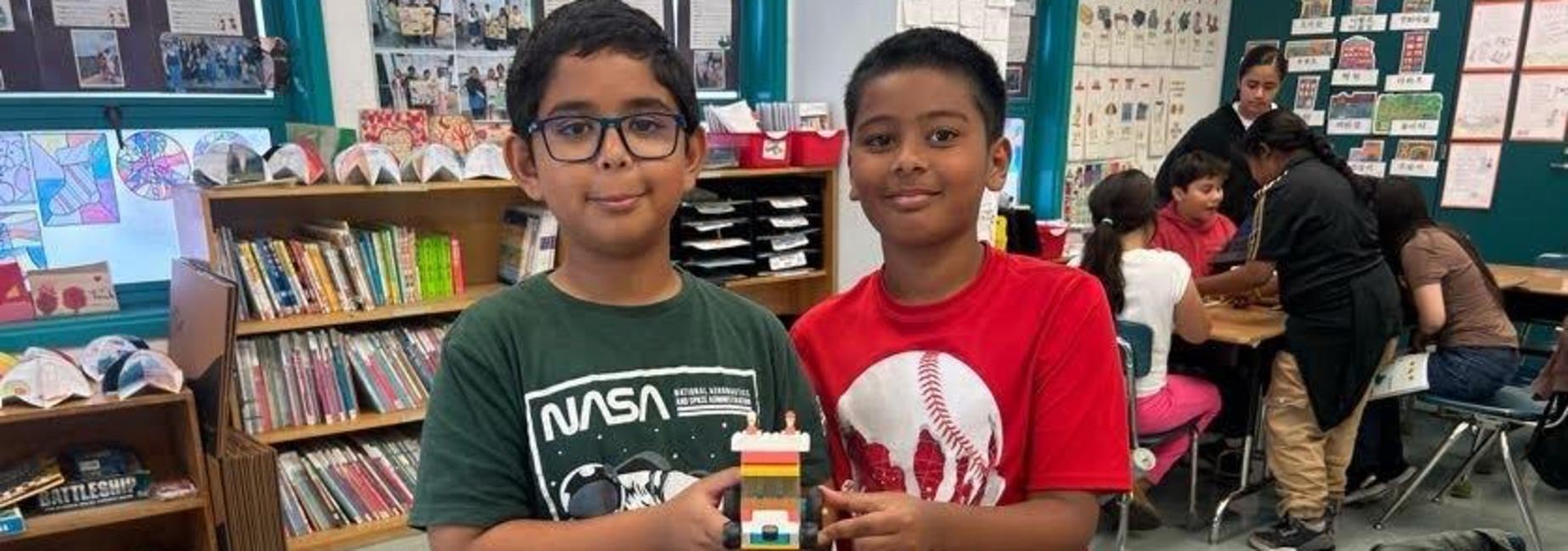 4th grade students at their classroom showing a robotic project