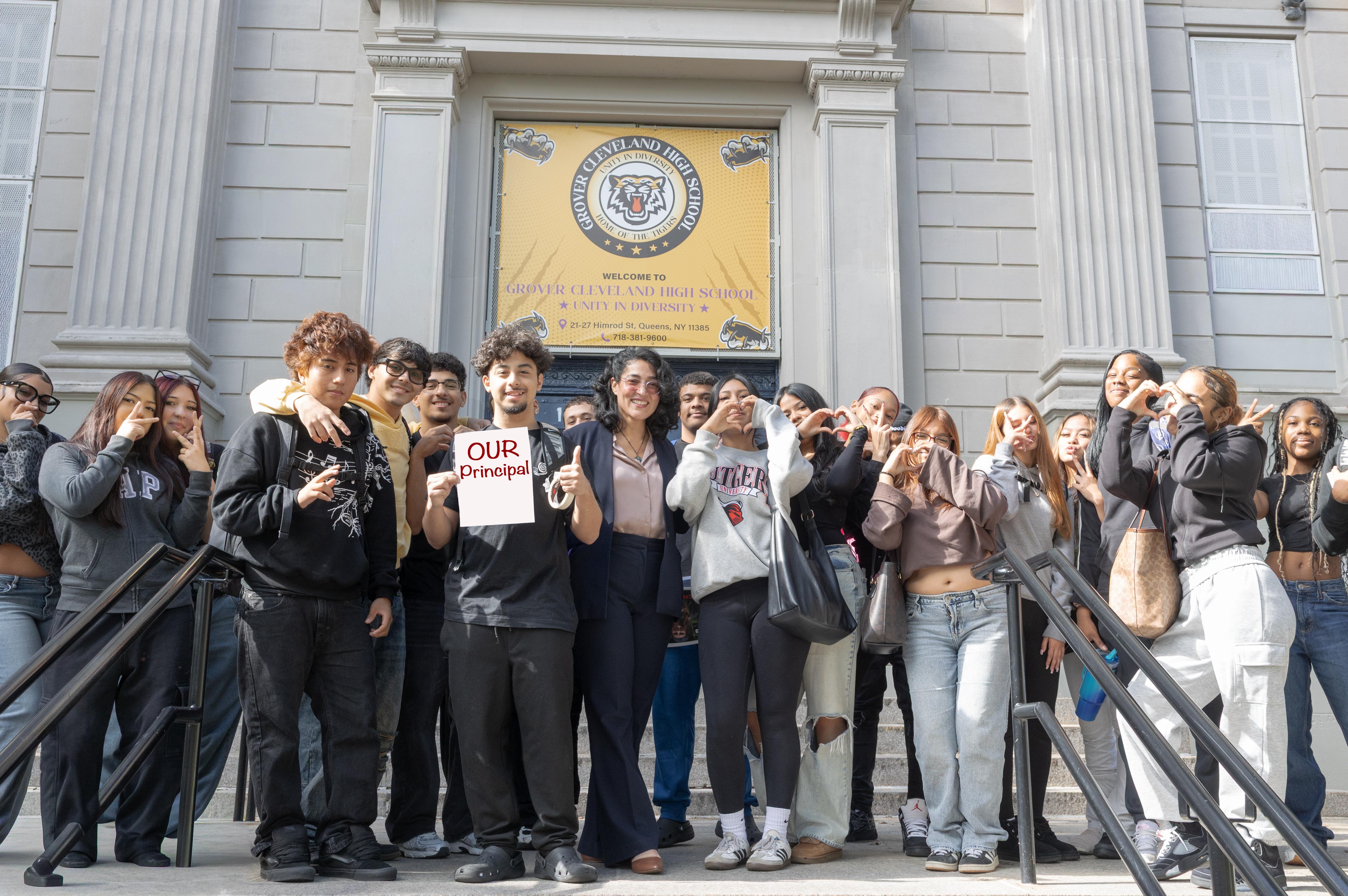 Photo with pricipal Ruiz-Toro with students in front of the building
