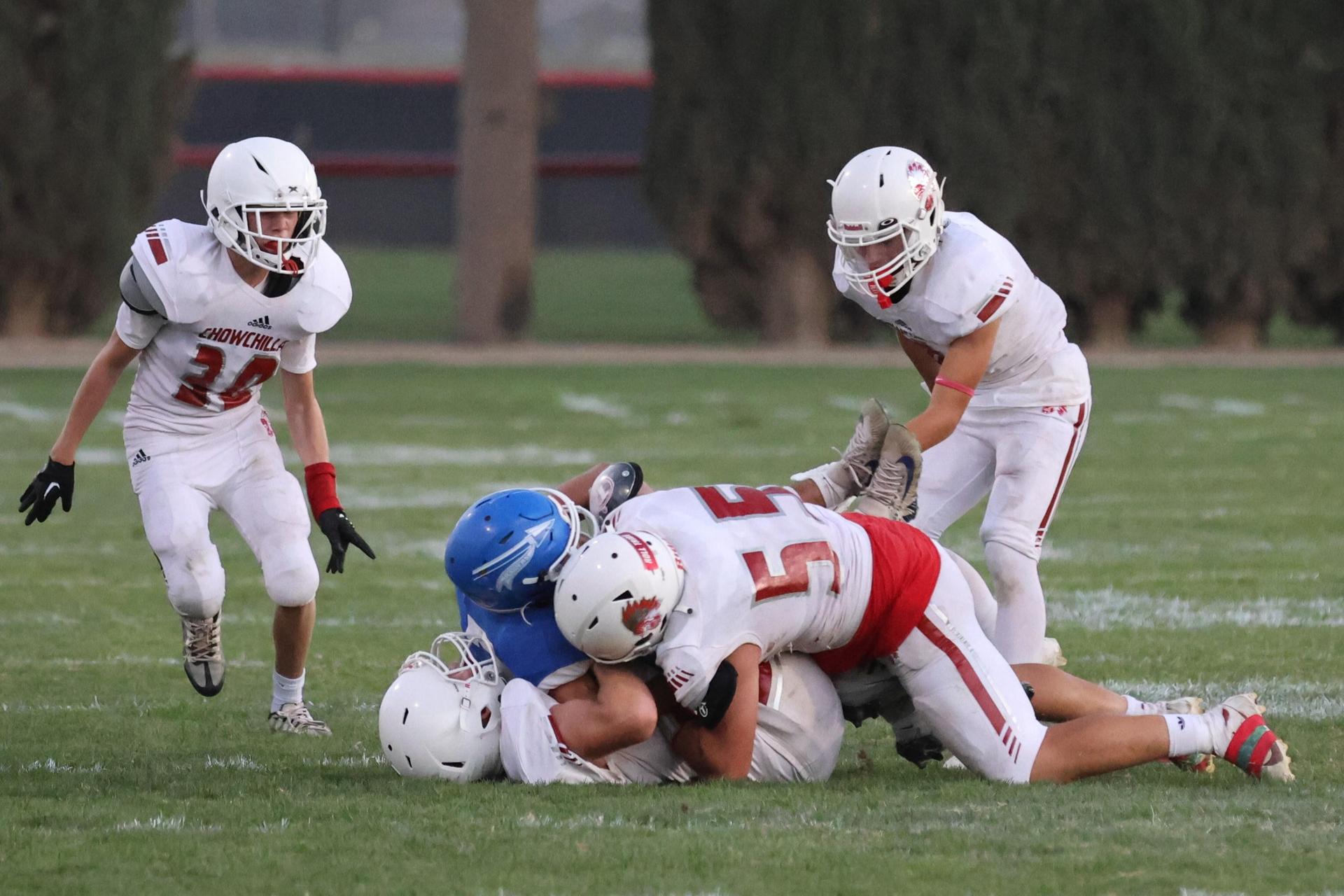 Junior Varsity football players in action against Caruthers