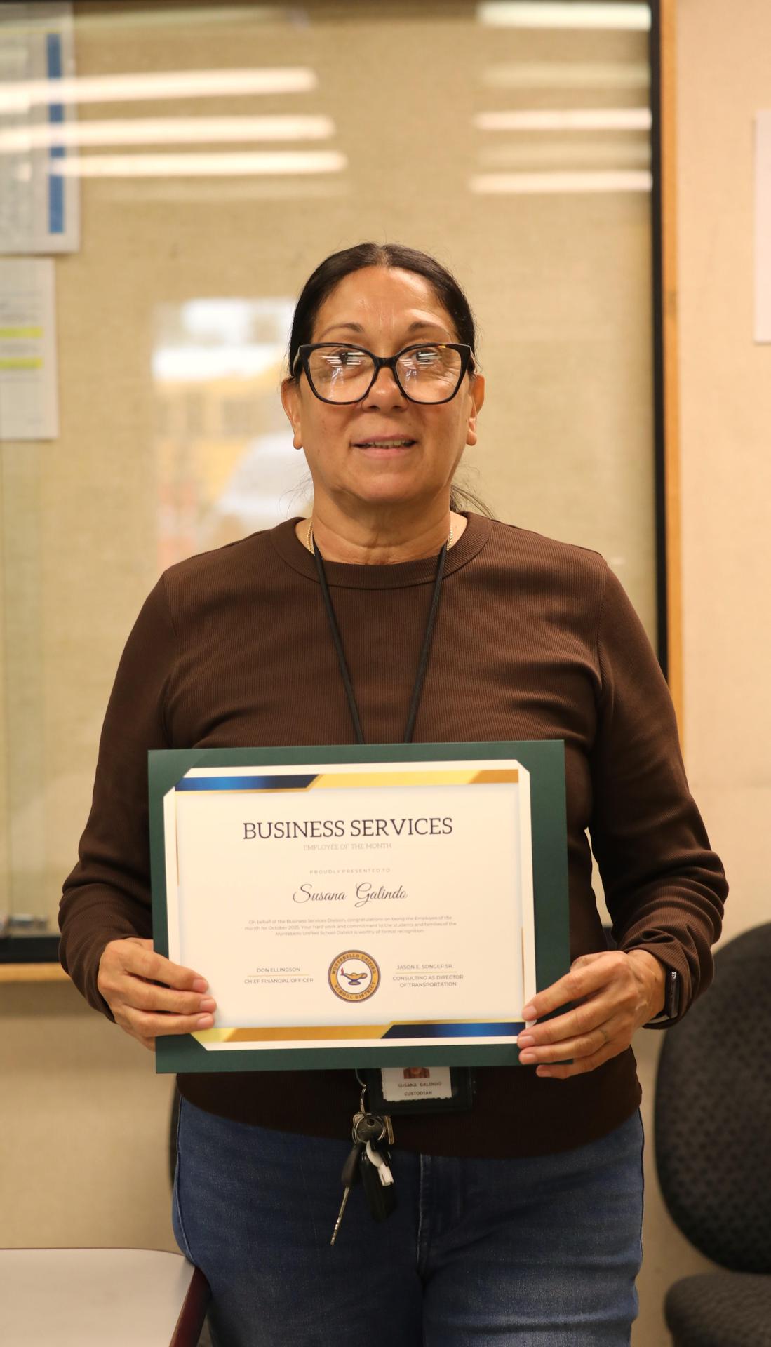 Picture of employee holding certificate 