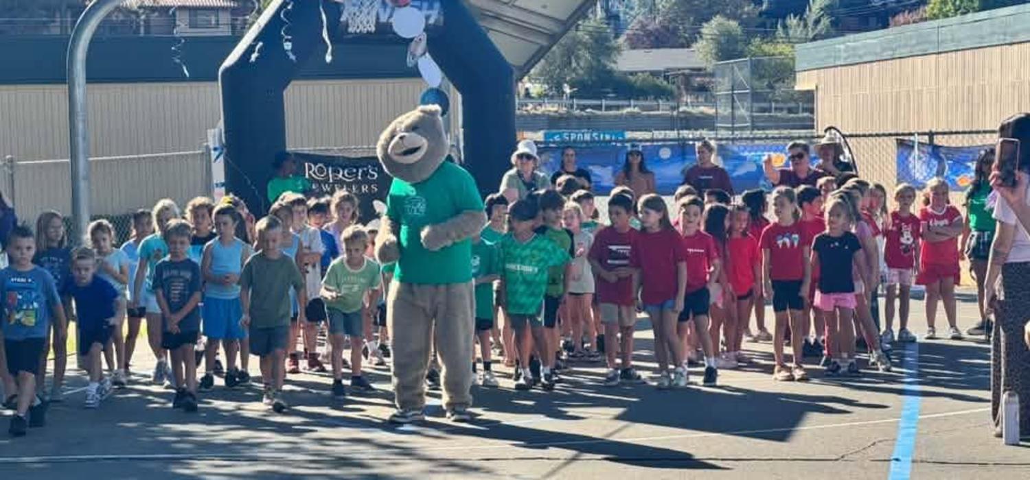 Cubby mascot and students at the Jog a Thon starting line