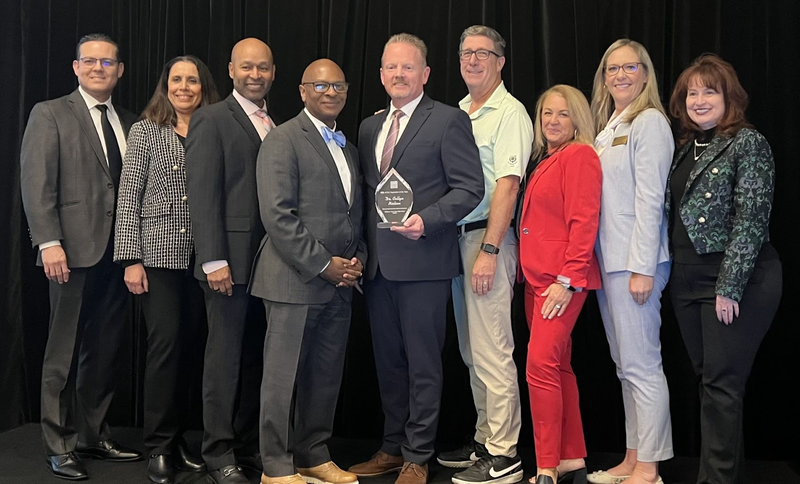 Dr. Collyn Nielsen and ACSA members posing with an award