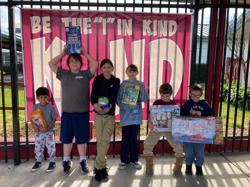 Students holding a toy