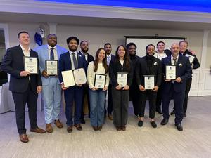Image of 12 men and women holding their hall of fame certificate