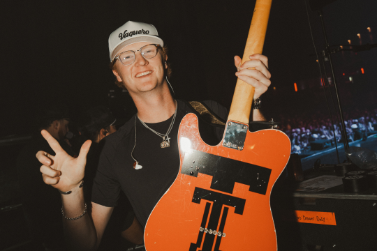 gage mcneely smiling with guitar