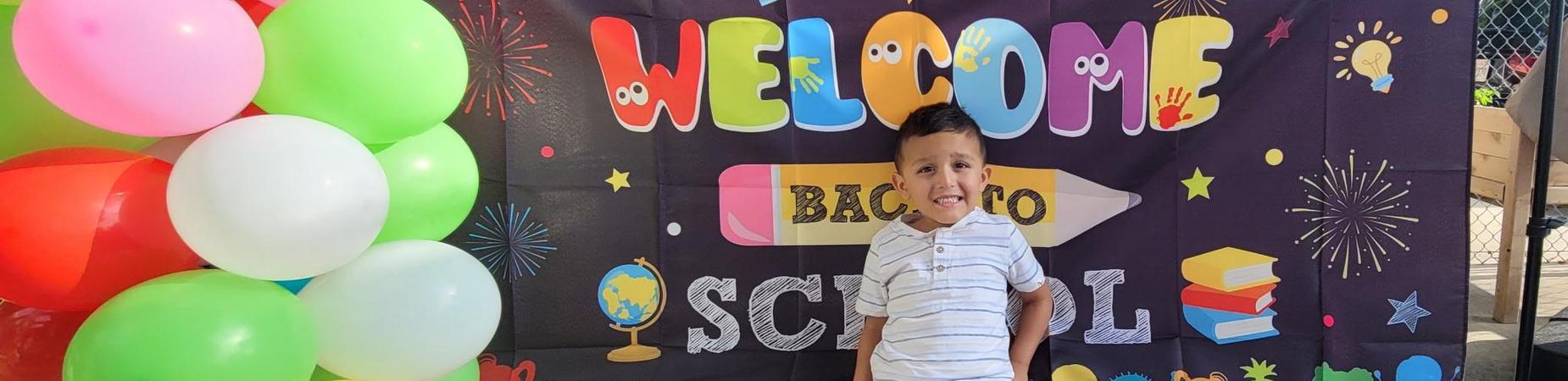 Picture of student in front of sign