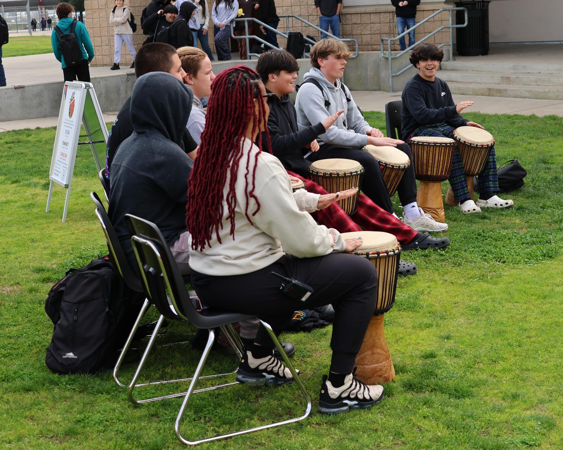 students and staff participating with the African Drum Interactive