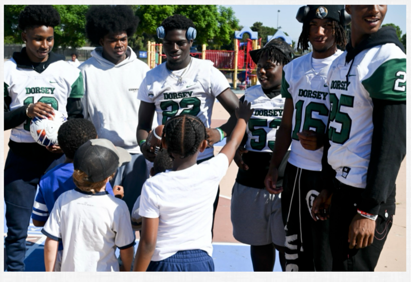 Dorsey HS football players play enthusiastically with the students.