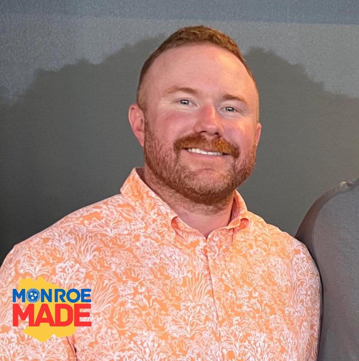 Brad West wearing orange shirt with Monroe Made logo