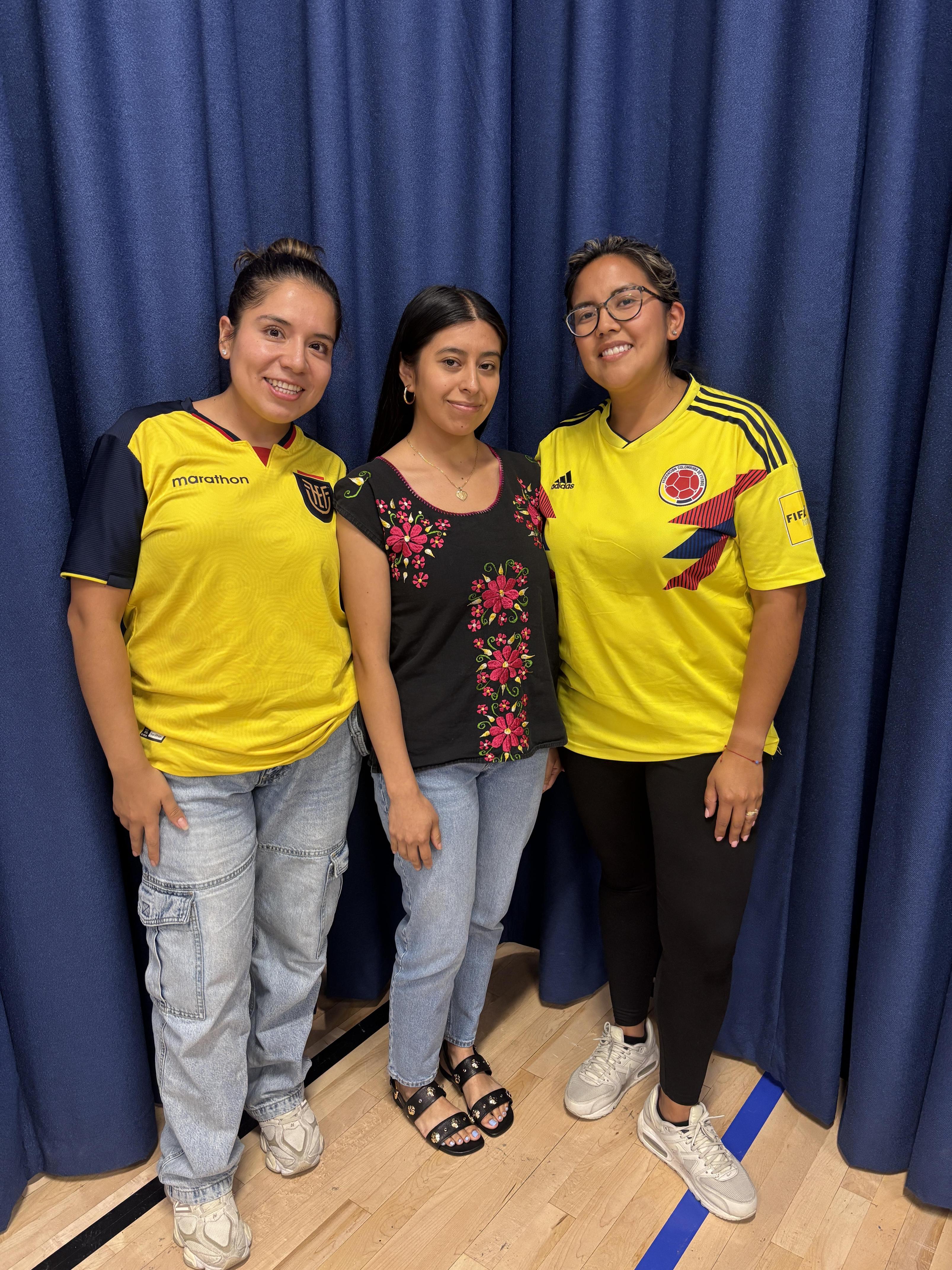 three teachers together wearing soccer jerseys