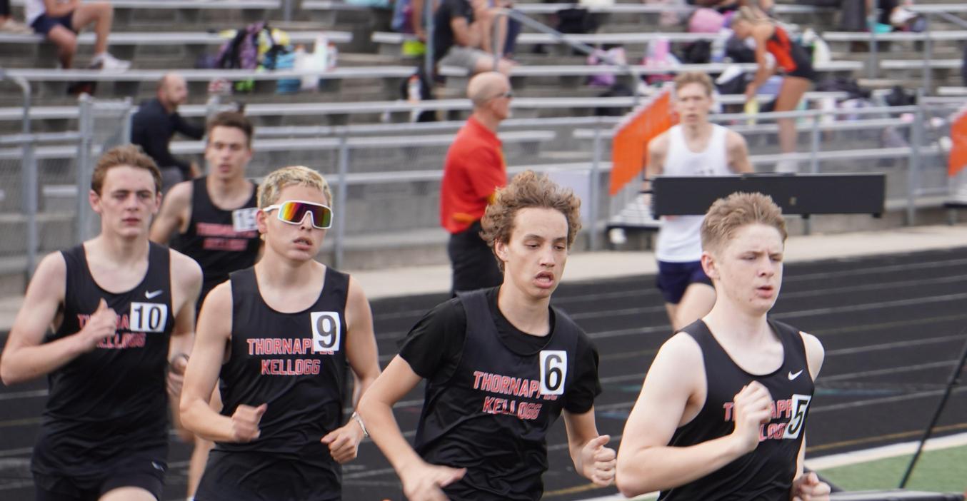 Five TK runners race around the track.
