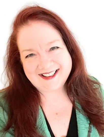 Headshot of keynote speaker Pamela Broussard smiling, wearing a green blazer