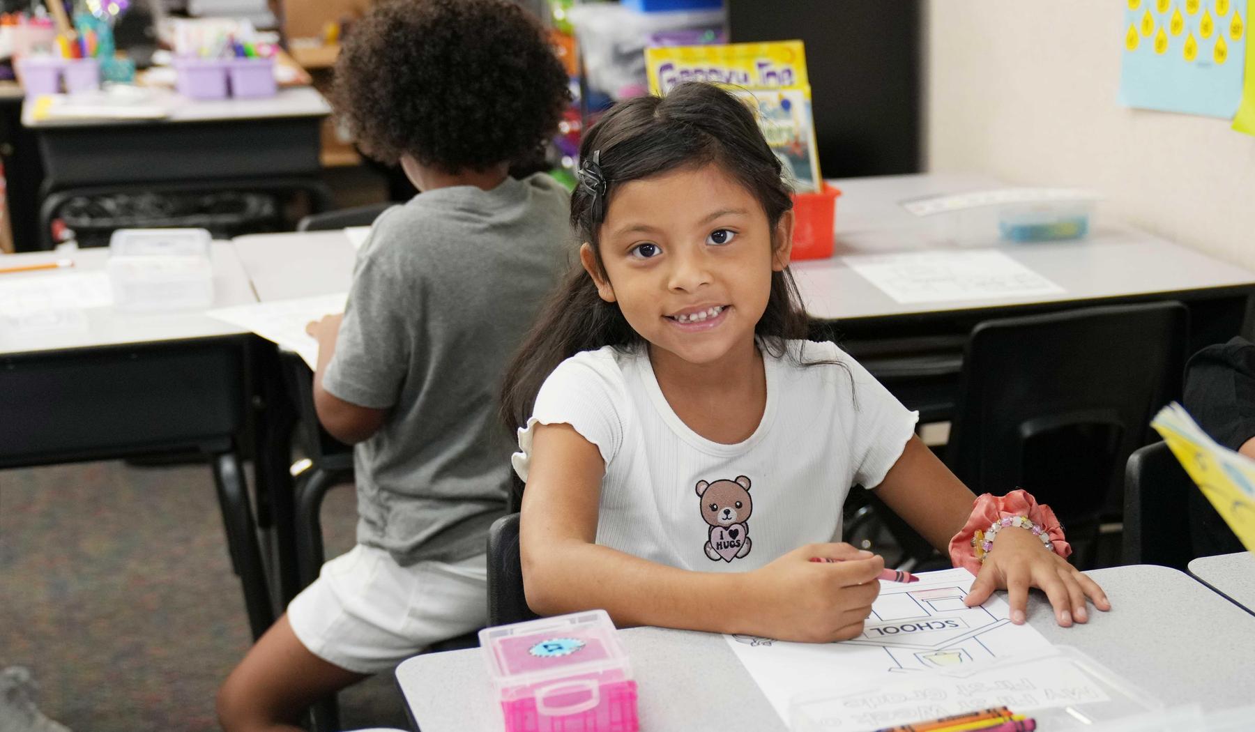 one girl coloring picture in class