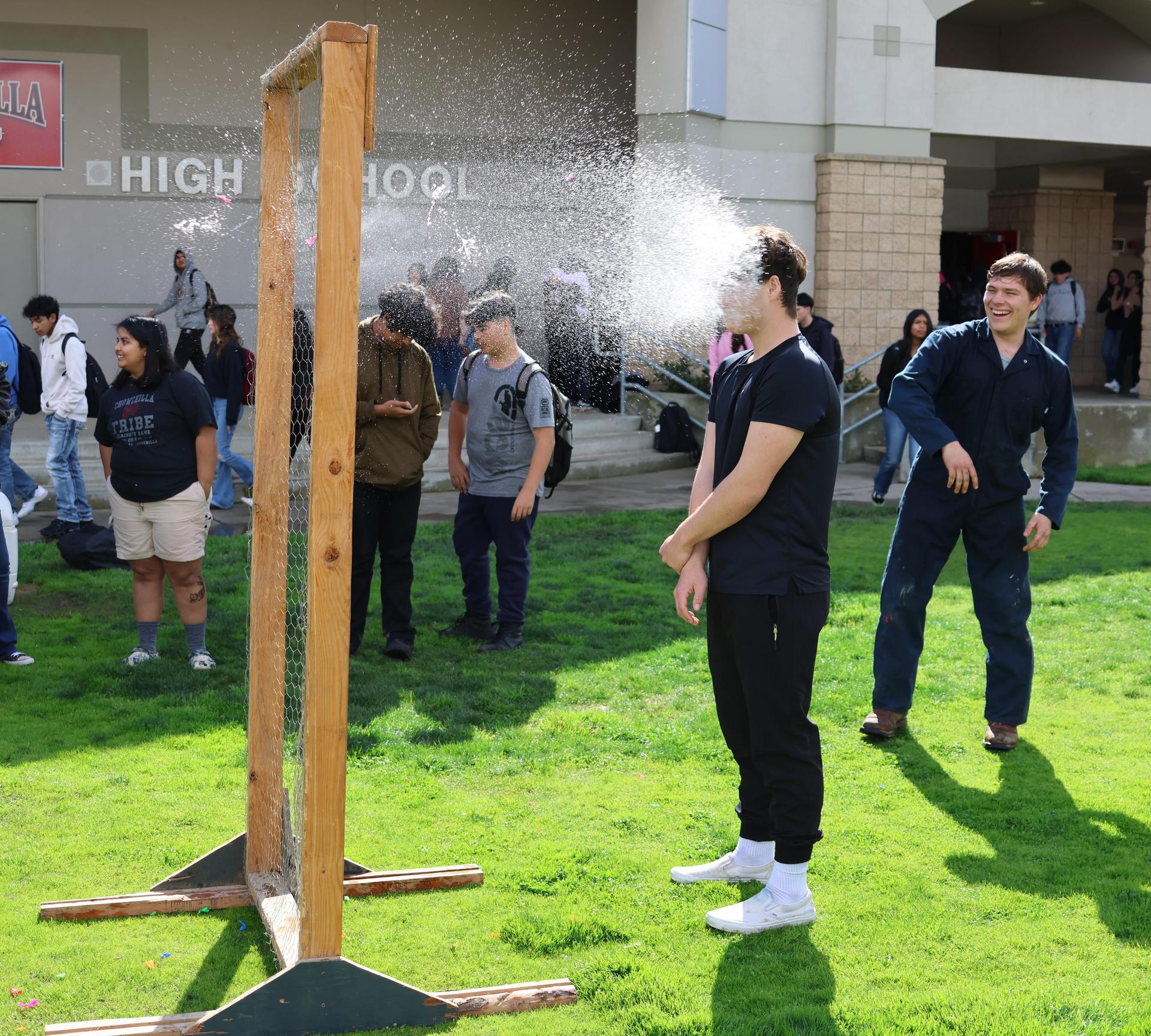students and staff enjoying the water balloon toss