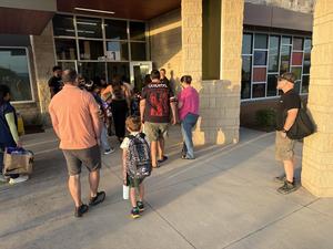 Families enter Thornton Elementary on the first day of school