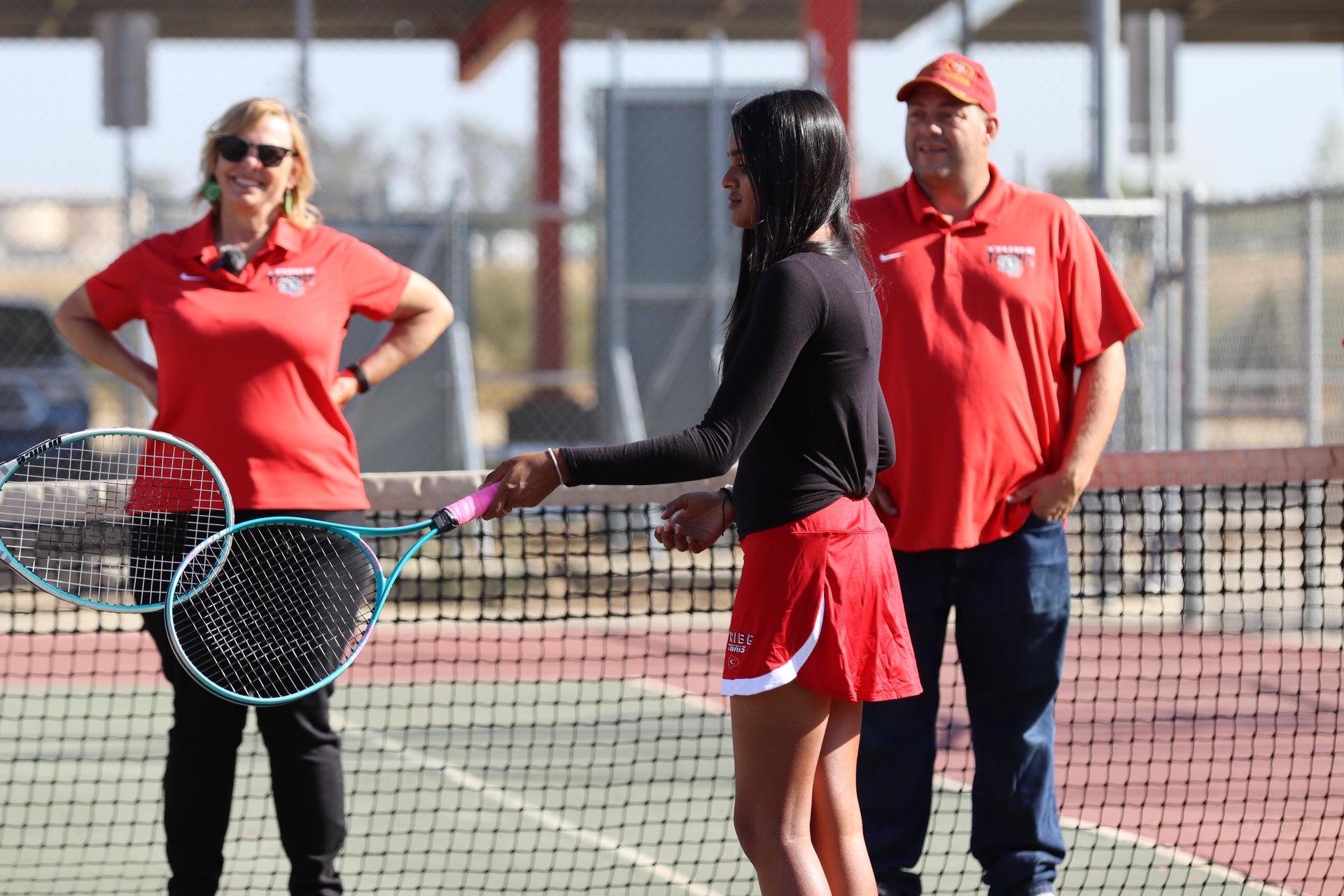 tennis players, family, and staff celebrating senior night