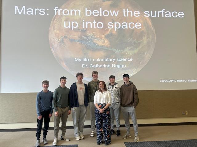 boys standing against Mars projection with guest speaker