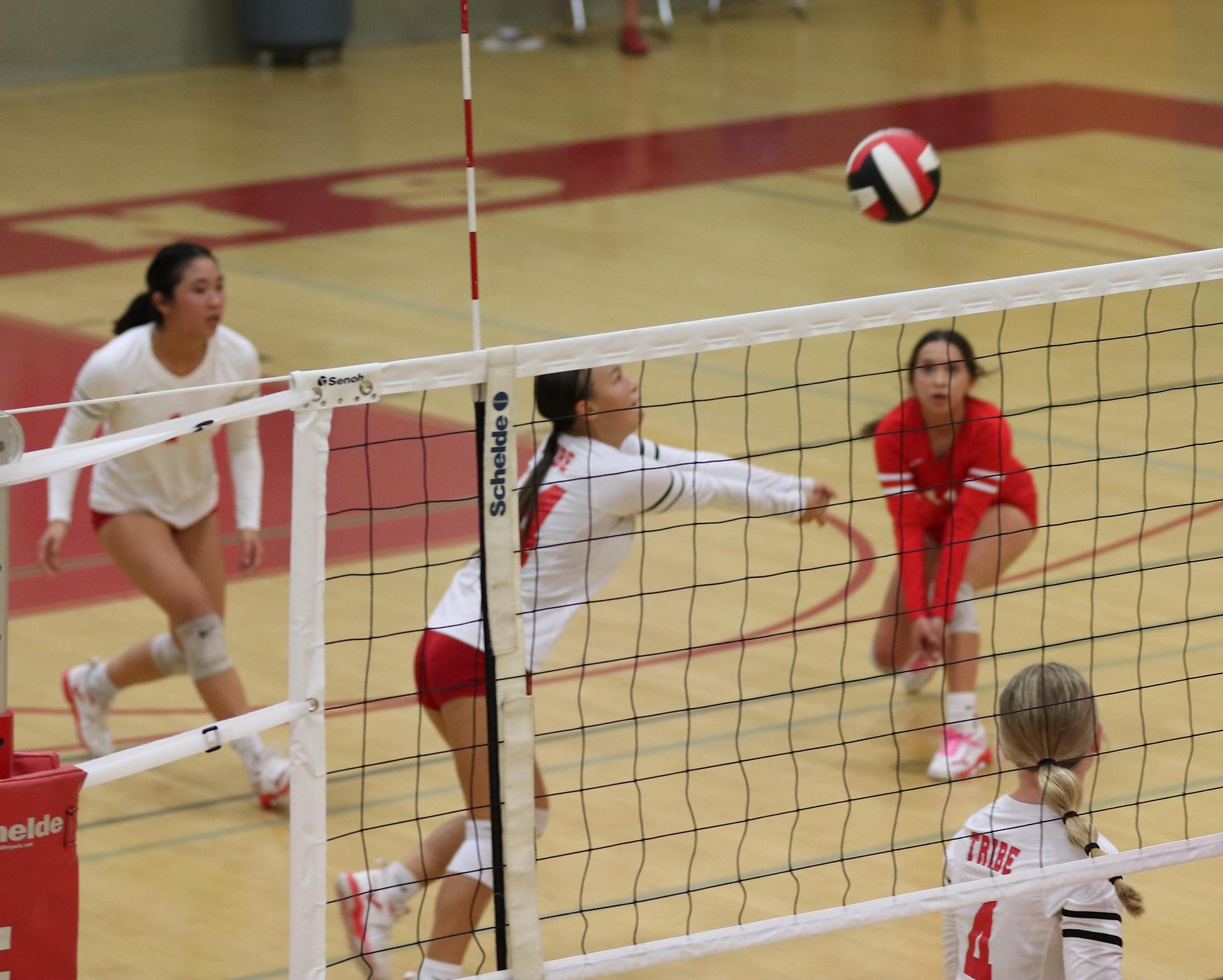 varsity volleyball players in action against Minarets