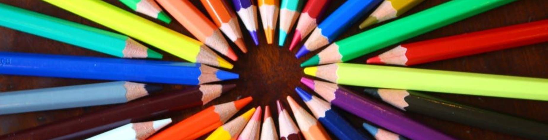 Colorful arrangement of various colored pencils in a circular pattern.