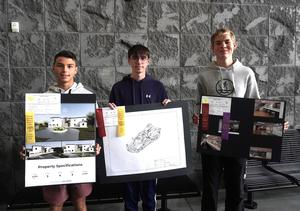 Three students show their projects from the state MITES competition.