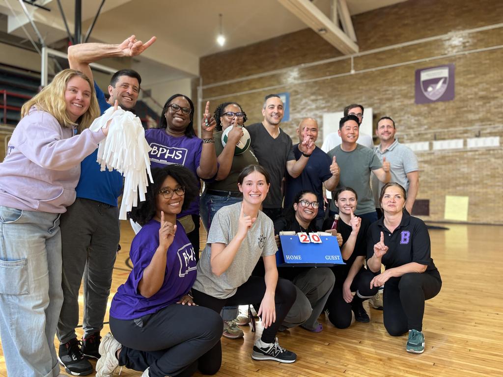 Teachers and Staff pose for a picture after the student vs. staff volleyball game