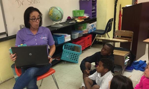 Mrs. Monique Smith sharing One Fish Two Fish Red Fish Blue Fish with her class in Jamaican Patois Style for International Literacy Day.