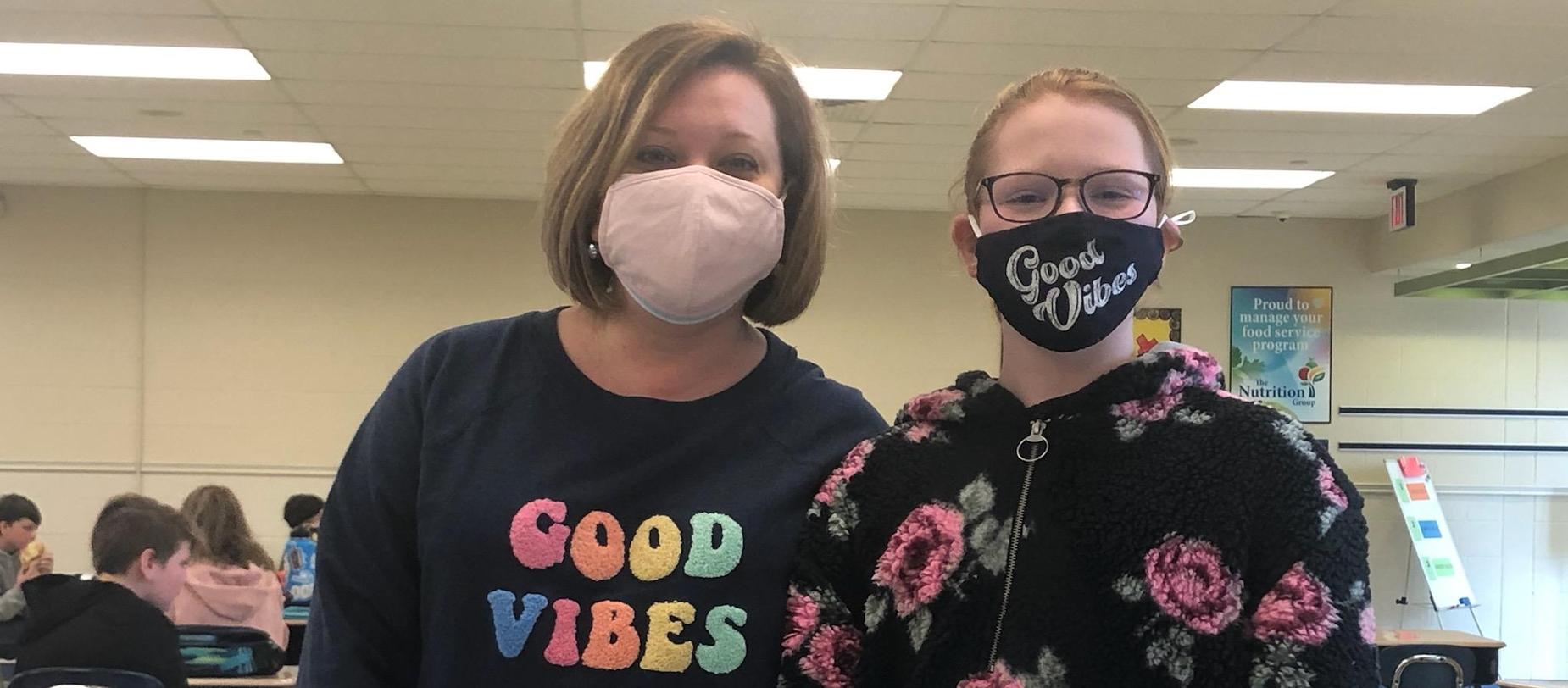 Teacher and student wearing good vibes clothing
