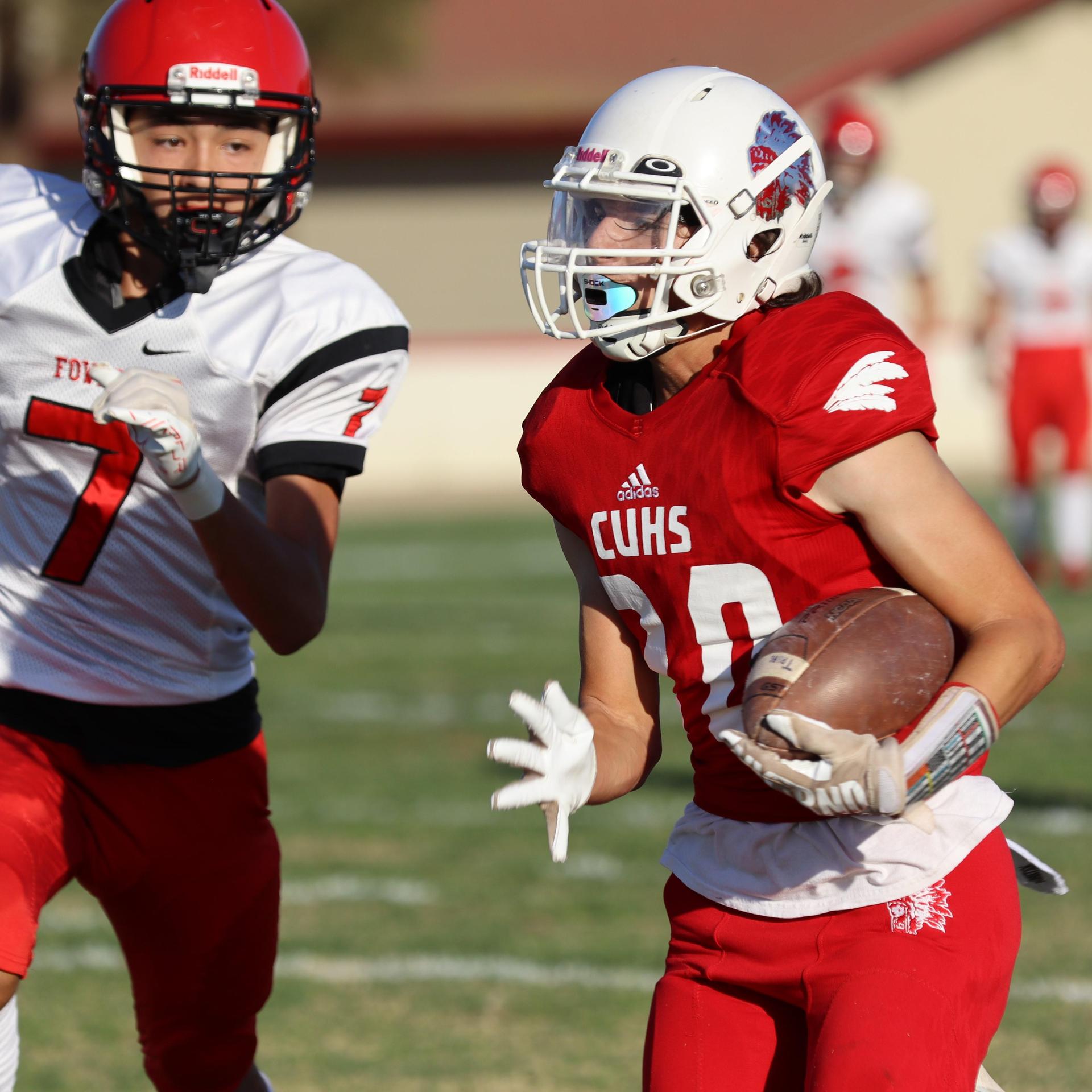 junior varsity football players in action against Fowler