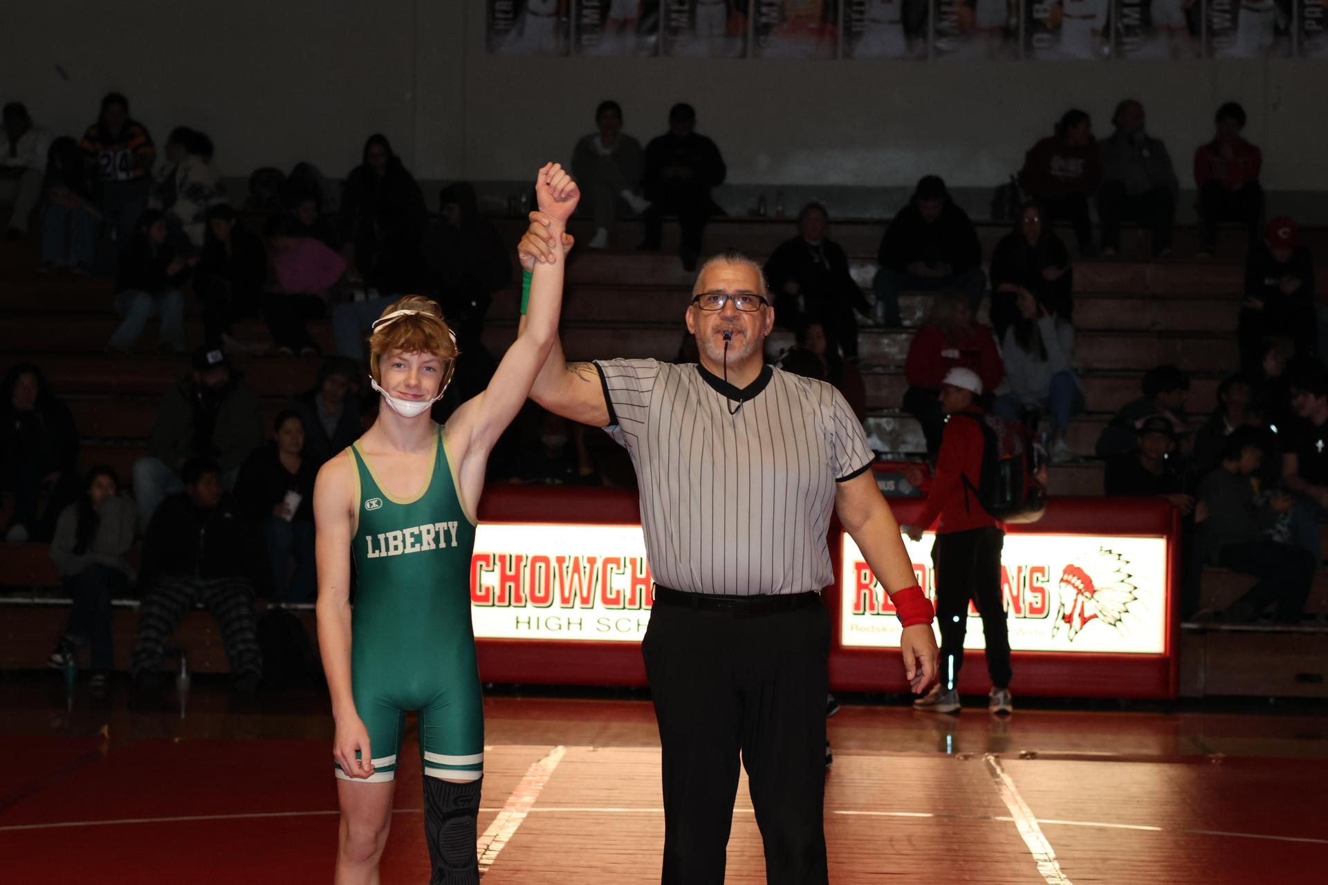 Wrestling winners with hands up 58