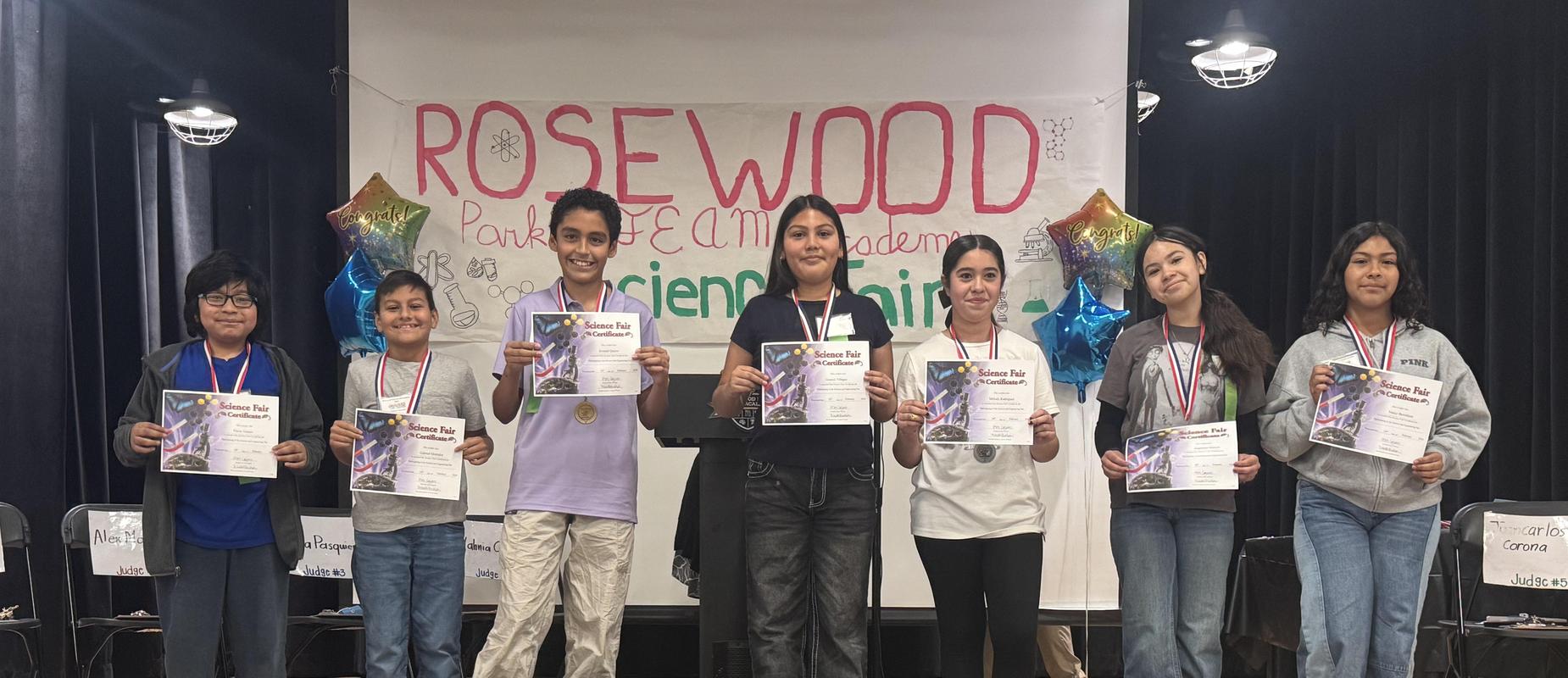 students holding certificates