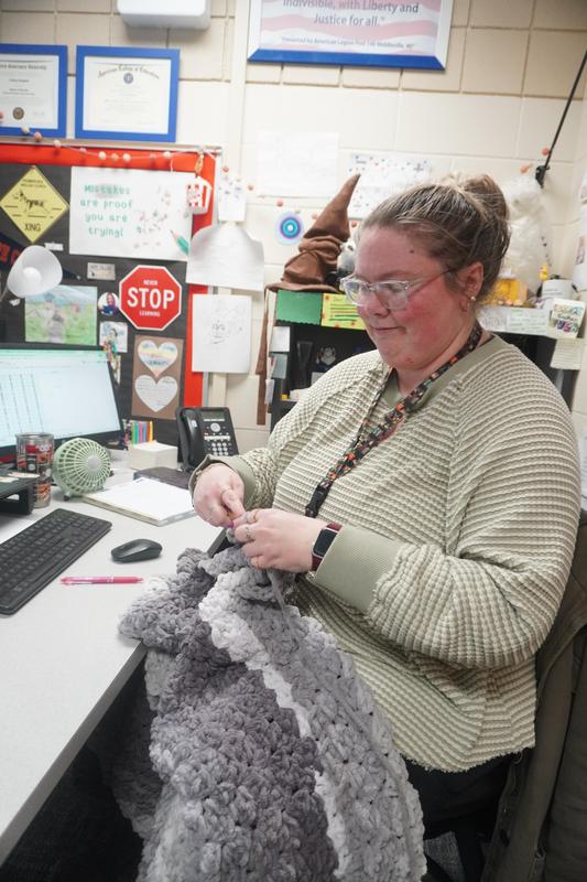 Lindsey Hoaglund works on a blanket during the Middle School crochet club time.