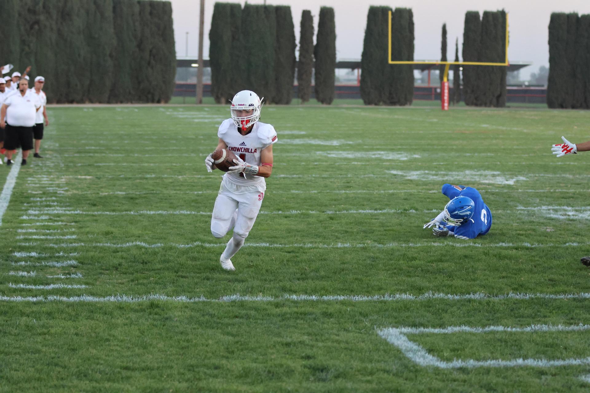 Junior Varsity football players in action against Caruthers