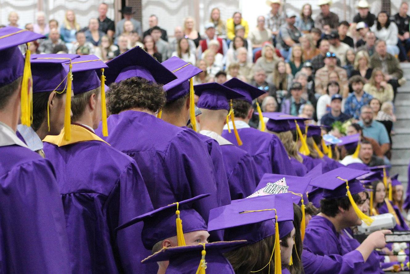 Graduates line up for their diplomas.