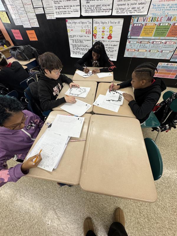 Students working on coding with a binary codes