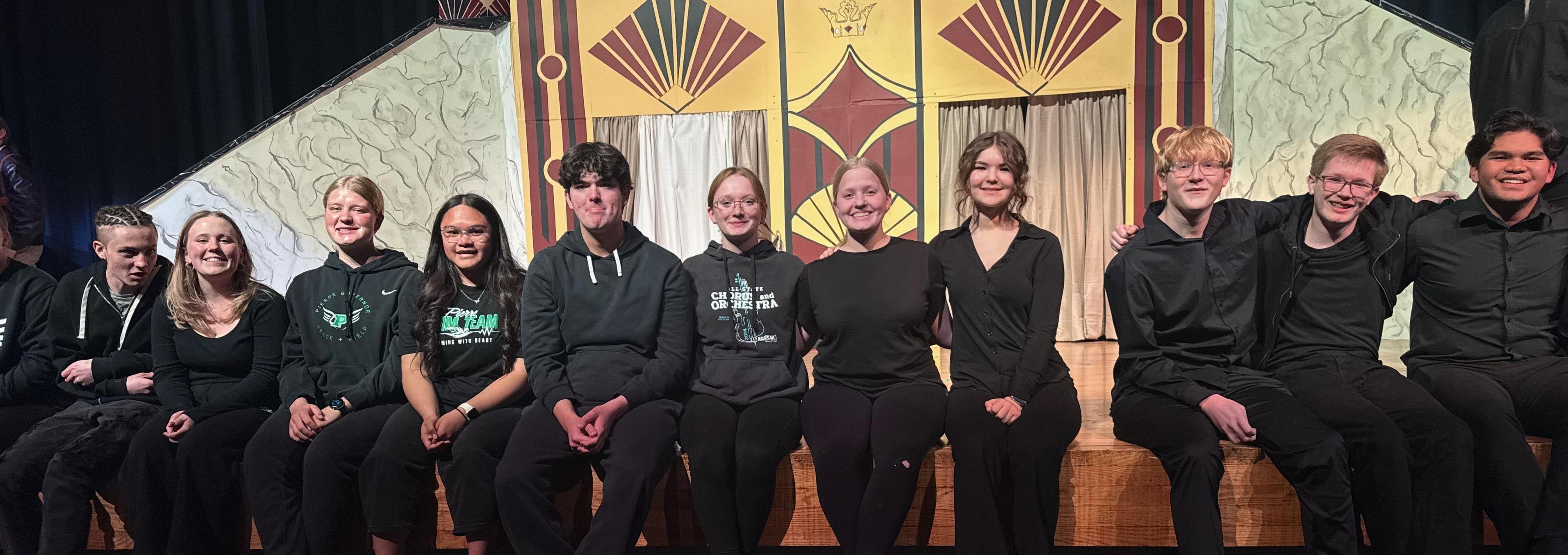 Fall play students sitting on Riggs stage.
