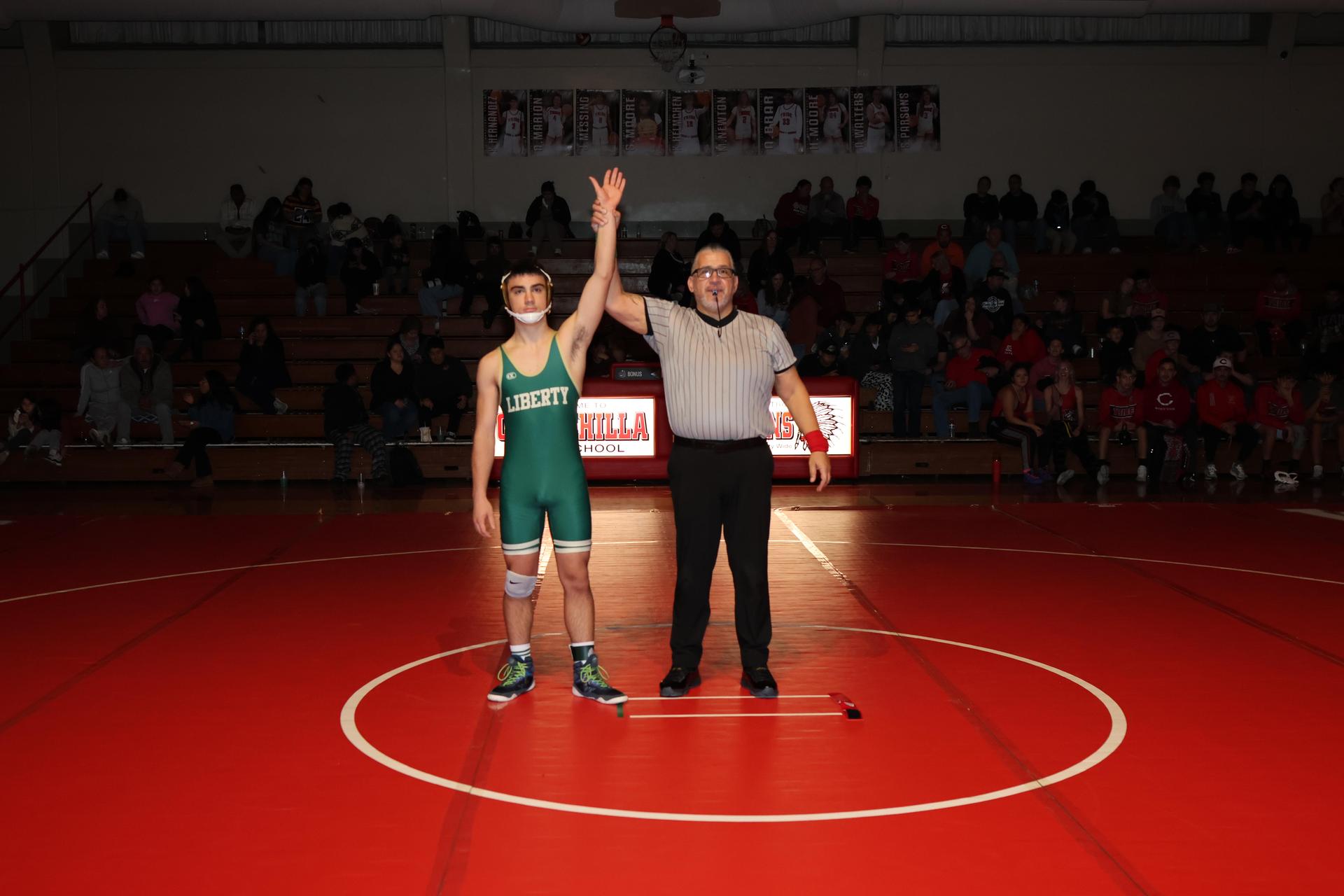 Wrestling winners with hands up 69