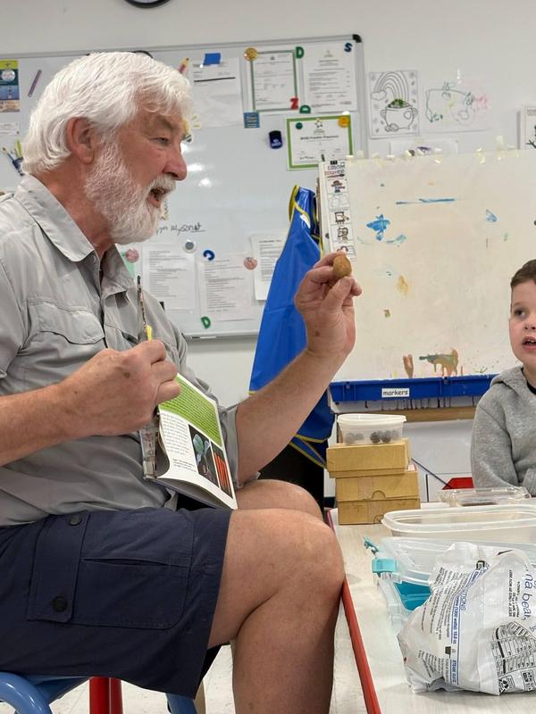 Mr. K showing students a seed